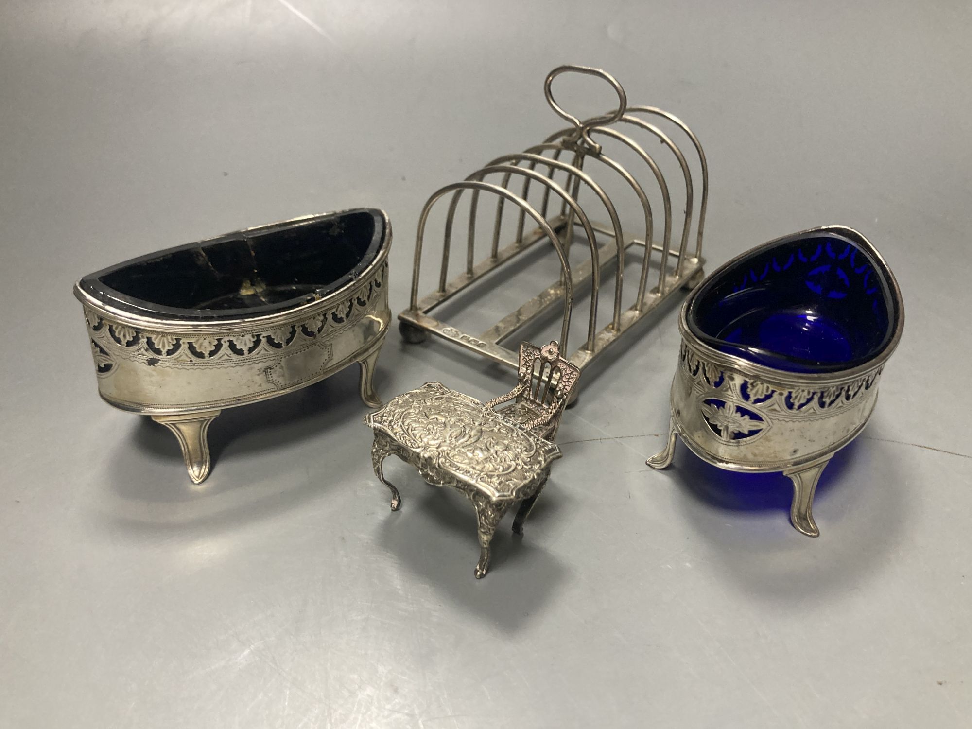 An Edwardian silver seven bar toastrack, William Hutton & Sons, Sheffield, 1909, a.f., a pair of George III silver salts etc.